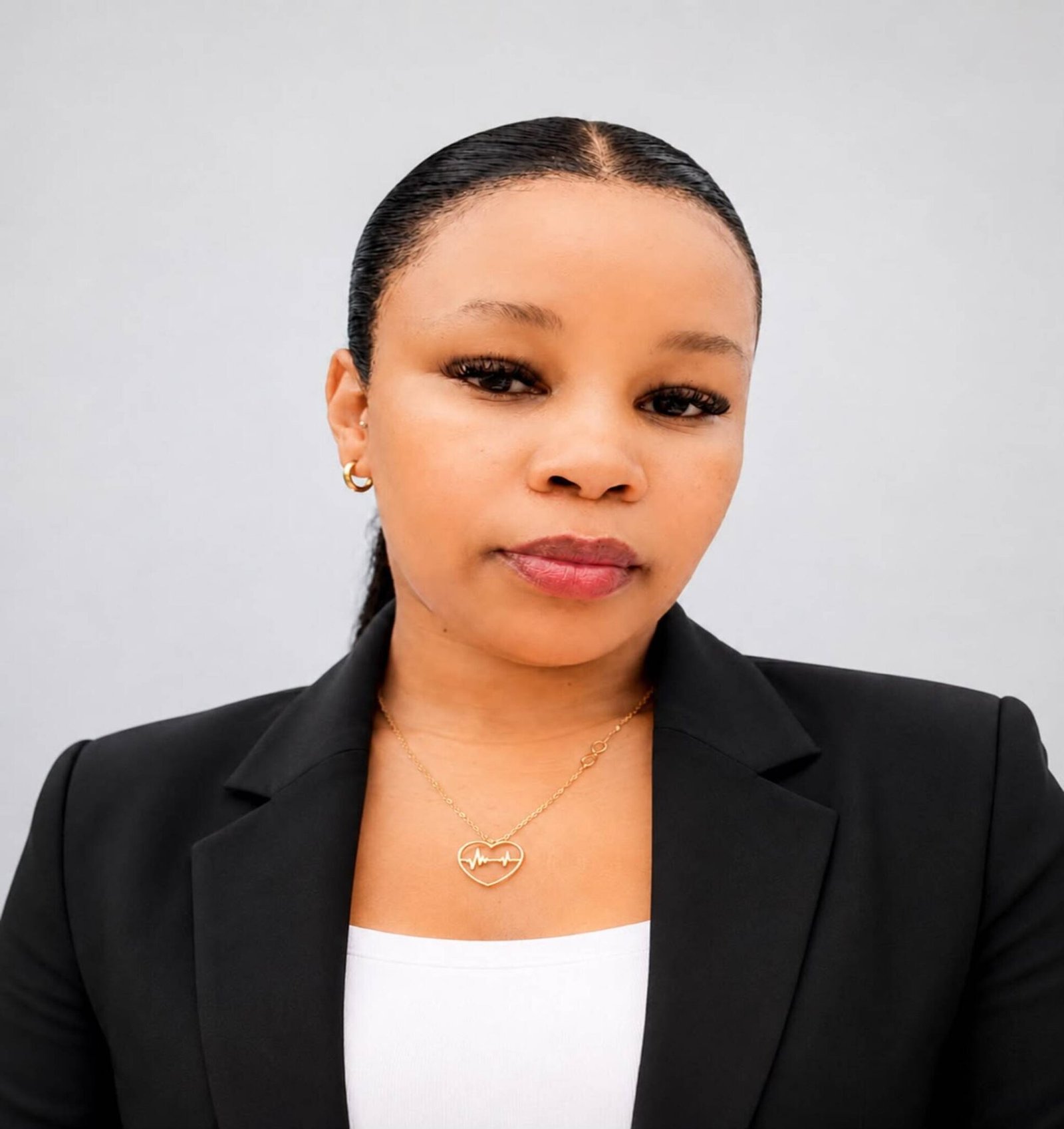 a young lady wearing a black blazer & white t shirt